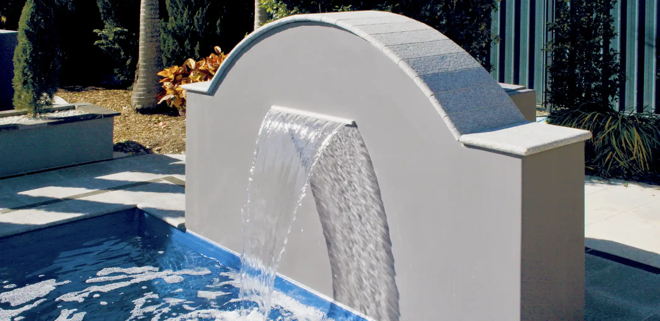 Add a wter feature to your backyard pool